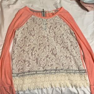Long sleeve shirt that is white/cream with pink sleeves and back